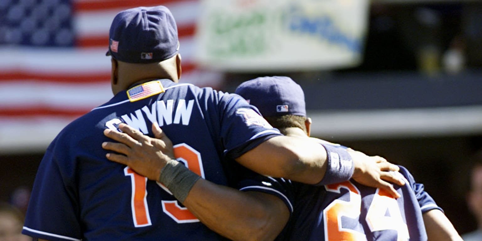 Tony Gwynn, left, and Rickey Henderson embrace while wearing San Diego Padres uniforms in an archival photograph.