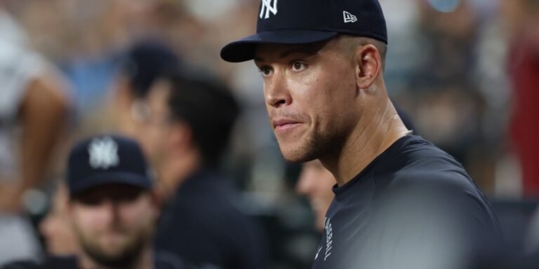 Aaron Judge in a Yankees cap and navy shirt, pictured in MLB.com’s October 3 ALDS roster report.