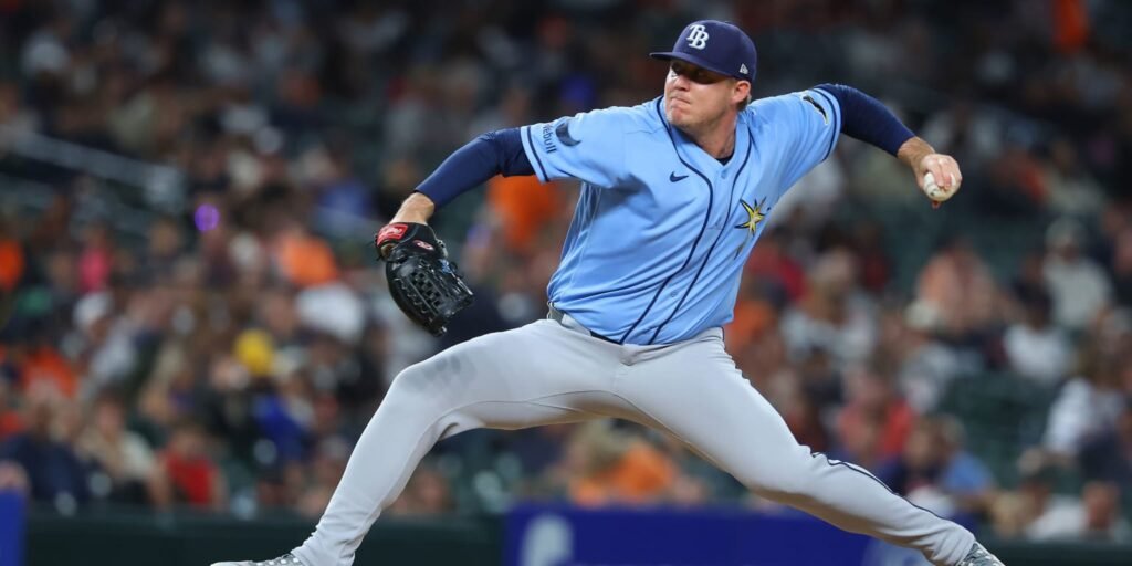 A Tampa Bay pitcher delivers a pitch in a light blue Rays uniform.