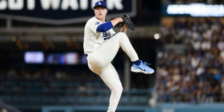 Tarik Skubal raises his right leg while pitching in a white Dodgers uniform.