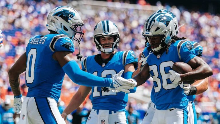 Ja&rsquo;seem Reed holds the ball beside Panthers teammates during a preseason game.
