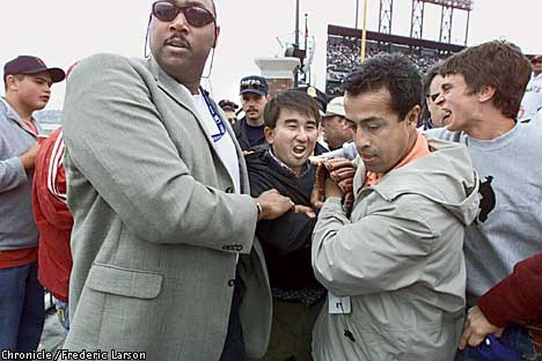Patrick Hayashi holding the baseball from Bonds’ 73rd home run