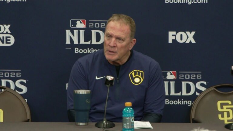 Pat Murphy sits at a microphone in a navy Brewers jacket after NLDS Game 3 at Petco Park.