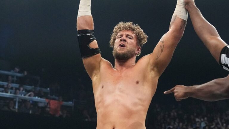 Will Ospreay raises his arms inside an AEW ring.