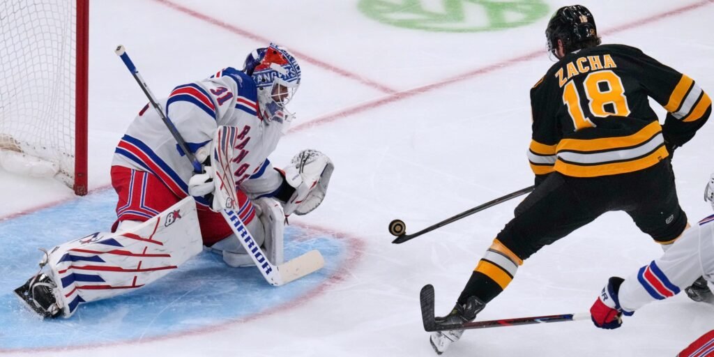 Igor Shesterkin stretches to save Pavel Zacha’s shot in front of the Rangers net.