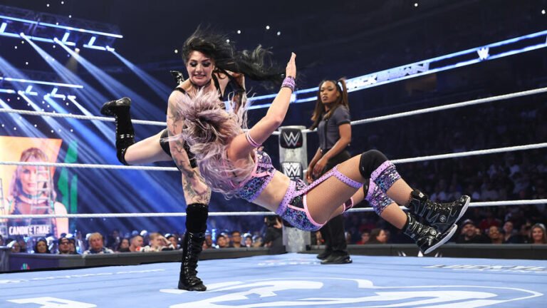 Two WWE SmackDown wrestlers compete inside the ring.