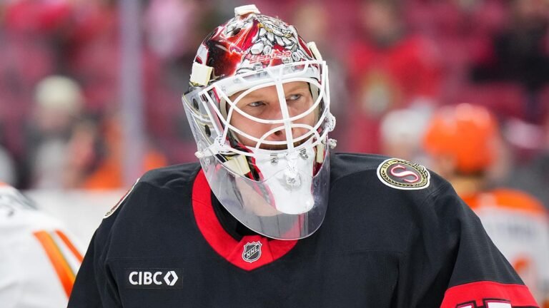 James Reimer wears an Ottawa Senators jersey and goaltender mask on the ice.