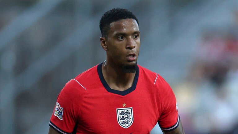 Ezri Konsa wearing England’s red away jersey.