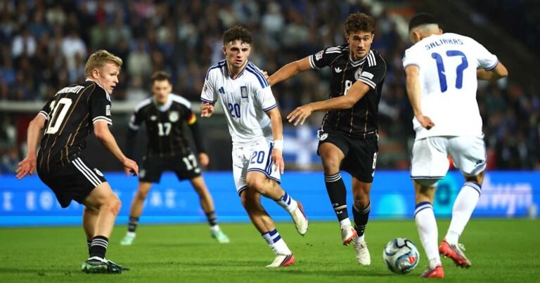 Germany players in black defend against Greece players in white.