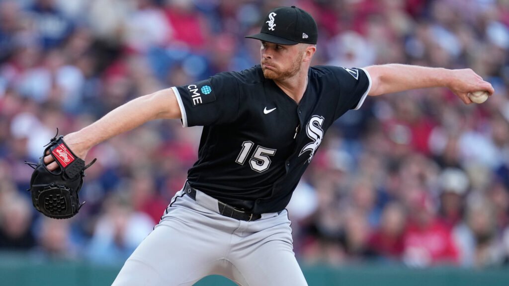 Sean Newcomb delivering a pitch in a black Chicago White Sox uniform.