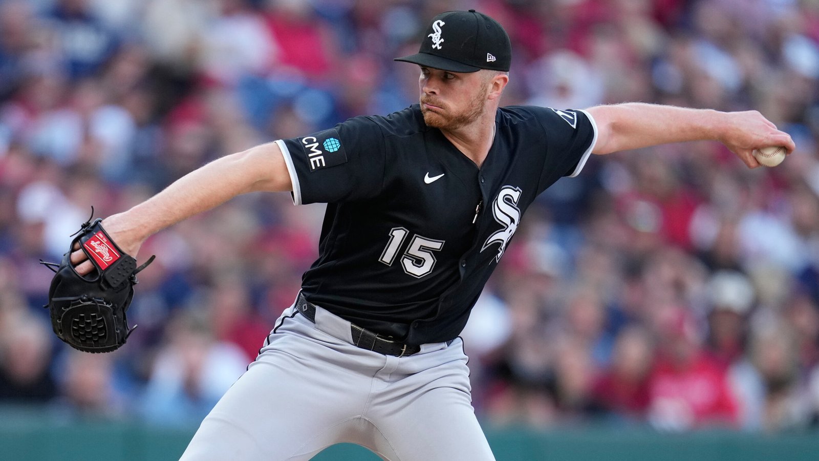 Sean Newcomb delivering a pitch in a black Chicago White Sox uniform.
