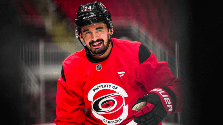 Seth Jarvis wearing a red Carolina Hurricanes practice jersey