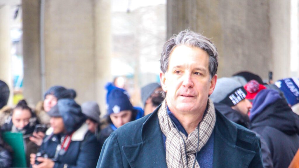 Brendan Shanahan wearing a dark coat at a Toronto Maple Leafs outdoor practice.