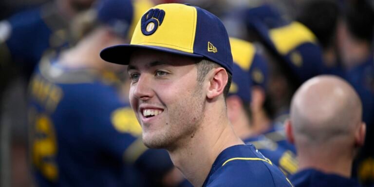 Jacob Misiorowski smiling while wearing a navy and yellow Milwaukee Brewers cap.