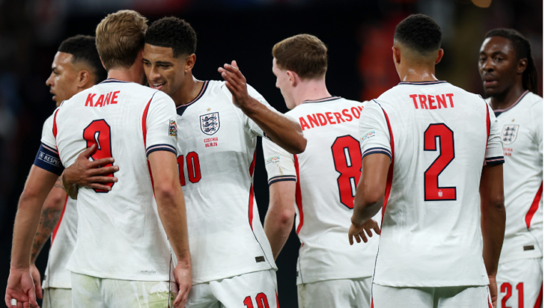 Harry Kane embraces Jude Bellingham as England teammates celebrate against Czechia.
