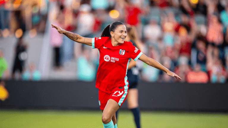Debinha celebrates for Kansas City Current with her arms extended.