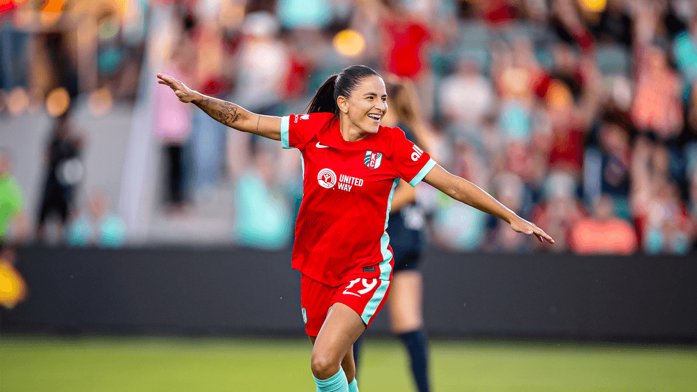 Debinha celebrates for Kansas City Current with her arms extended.