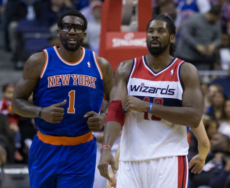 Amar’e Stoudemire in a blue New York Knicks uniform alongside Nene in a Washington Wizards uniform.