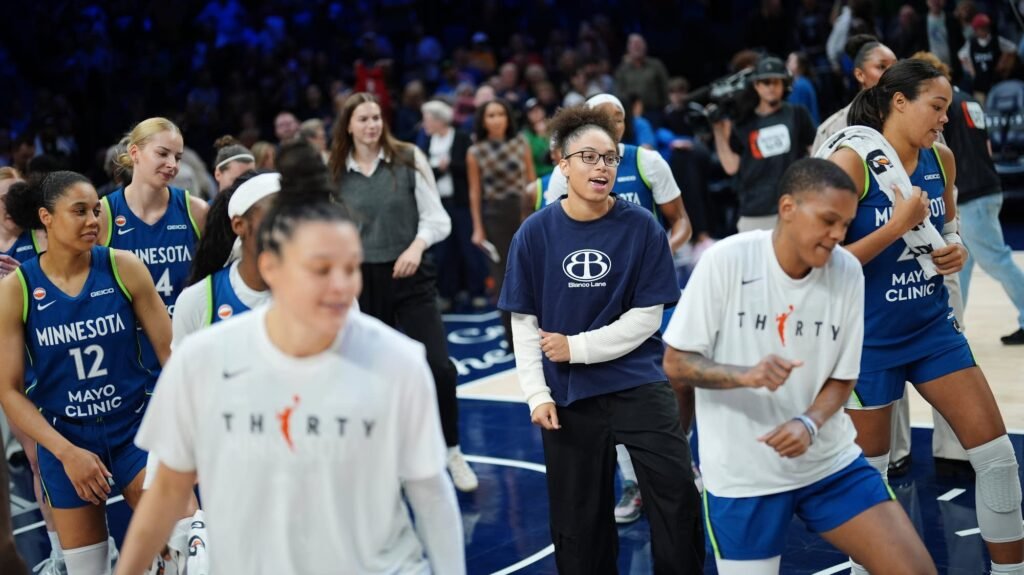 Minnesota Lynx players celebrate on the court after facing the Indiana Fever.