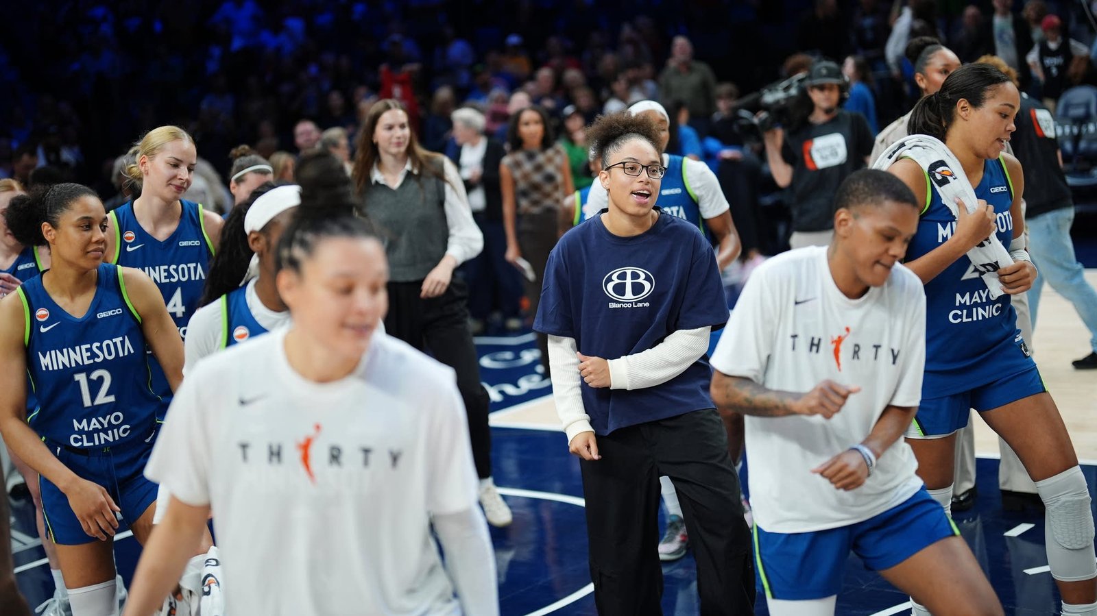 Minnesota Lynx players celebrate on the court after facing the Indiana Fever.