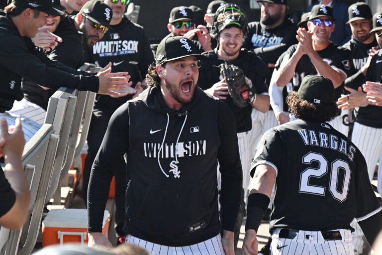 Mike Vasil reacting with White Sox teammates beside Miguel Vargas at Rate Field during the 2026 postseason.