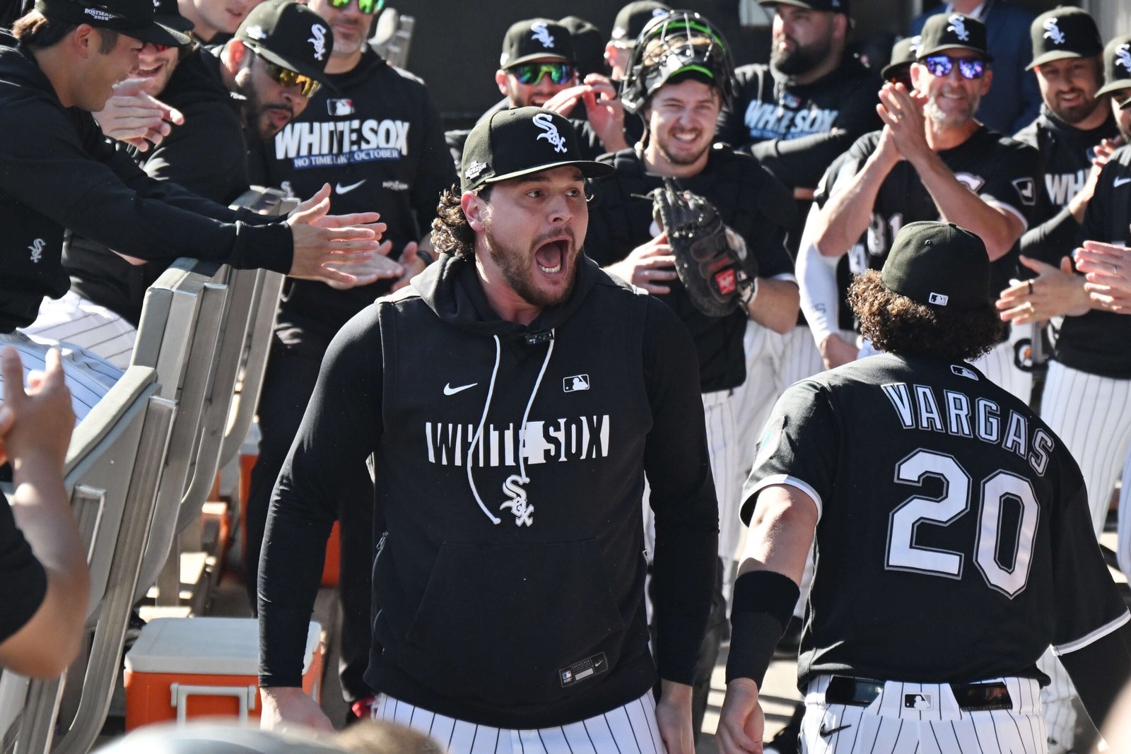 Mike Vasil reacting with White Sox teammates beside Miguel Vargas at Rate Field during the 2026 postseason.
