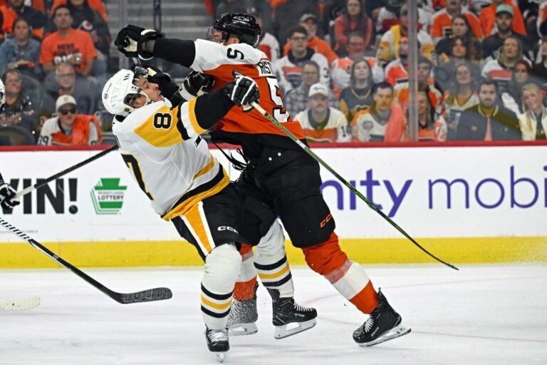 Rasmus Ristolainen checks Sidney Crosby during the Flyers–Penguins opener in Philadelphia on September 30, 2026.