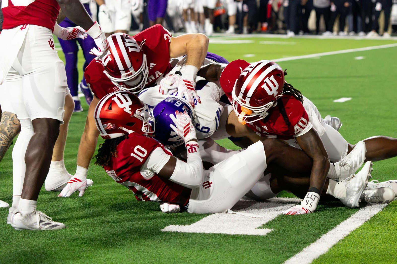 Indiana defenders converge on a Northwestern ball carrier in Bloomington on September 25, 2026.