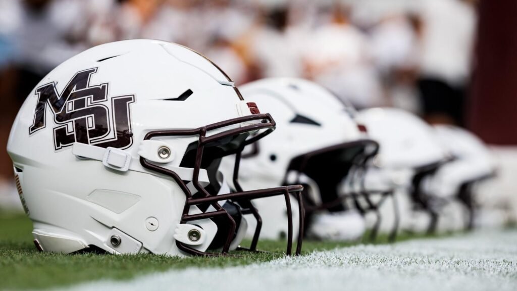 Mississippi State football helmets arranged on the sideline in a file photograph.