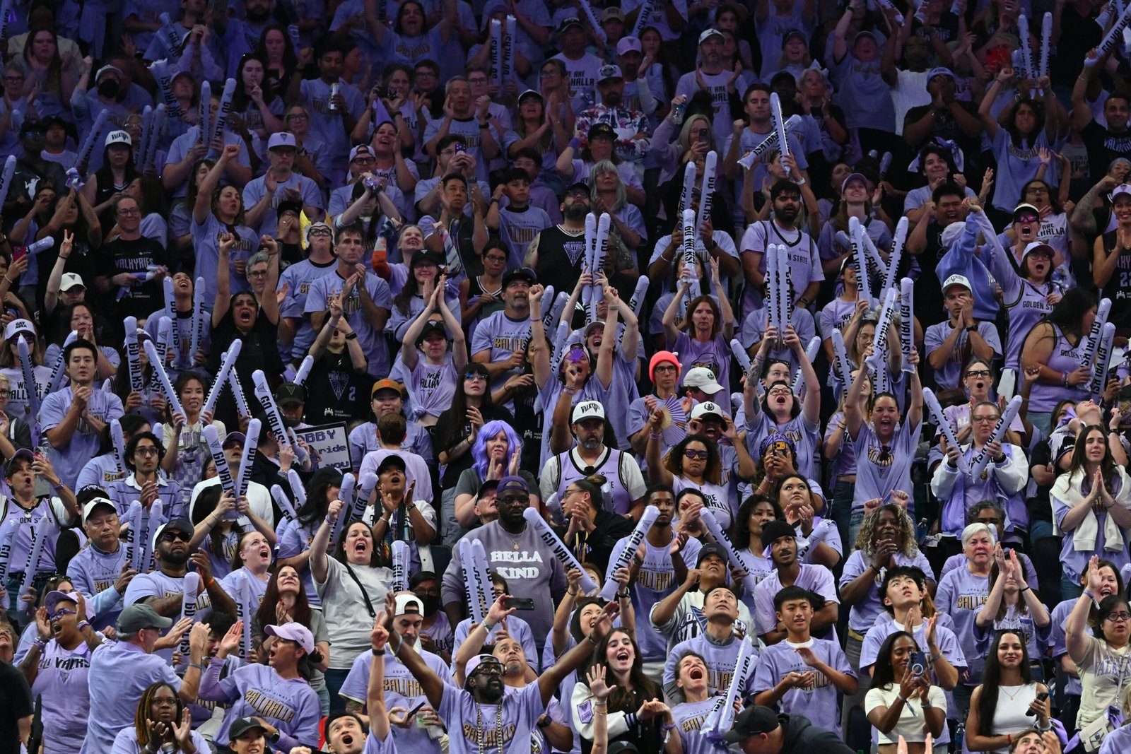 Golden State Valkyries supporters in purple cheer from the Chase Center stands