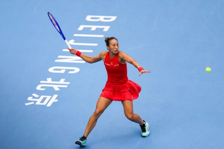 Zheng Qinwen hitting a forehand on the blue court at the China Open