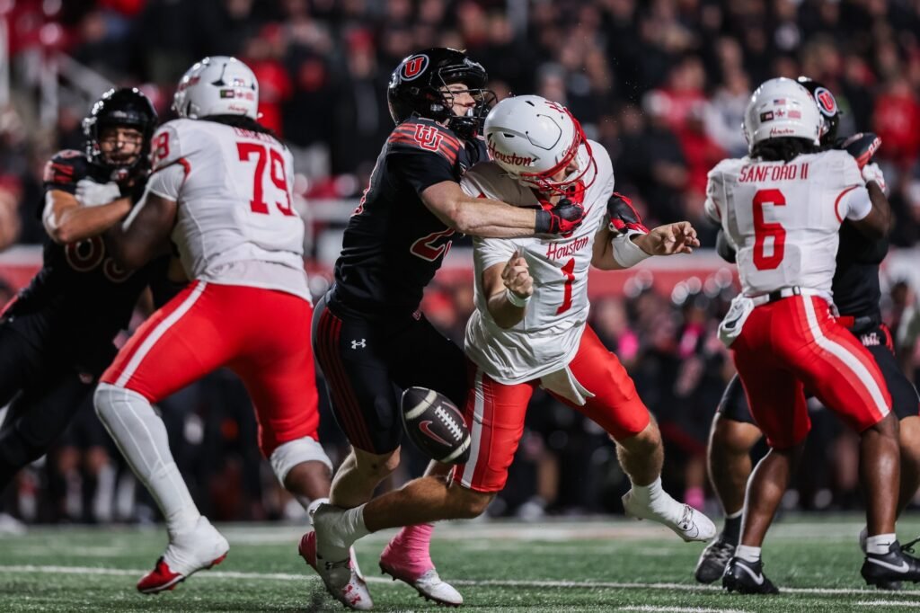 A Utah defender pressures Houston’s quarterback during the game at Rice-Eccles Stadium.