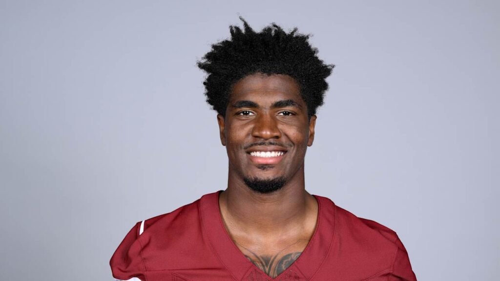 Rachaad White wearing a burgundy Washington jersey.