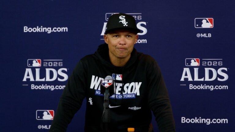 Will Venable in a black White Sox cap and hoodie speaks into a microphone in front of an ALDS backdrop.