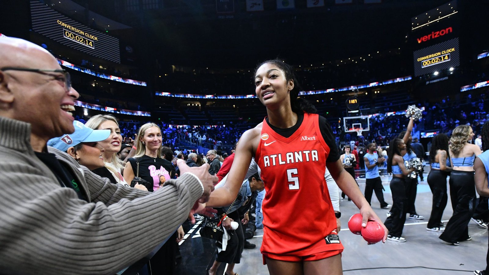 Angel Reese celebrates with fans after Atlanta’s Game 6 victory.