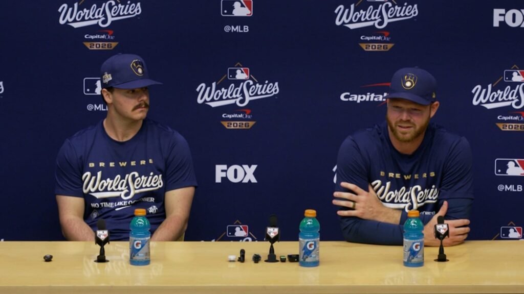 Brandon Woodruff, right, speaking beside another Brewers player at a 2026 World Series media session.