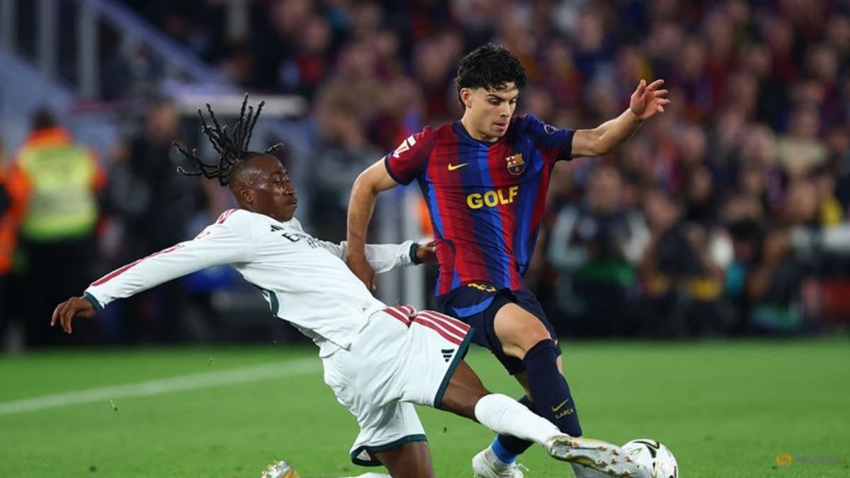 Barcelona’s Xavi Espart, right, controls the ball as Real Madrid’s Yan Diomande challenges him at Spotify Camp Nou on October 25, 2026.