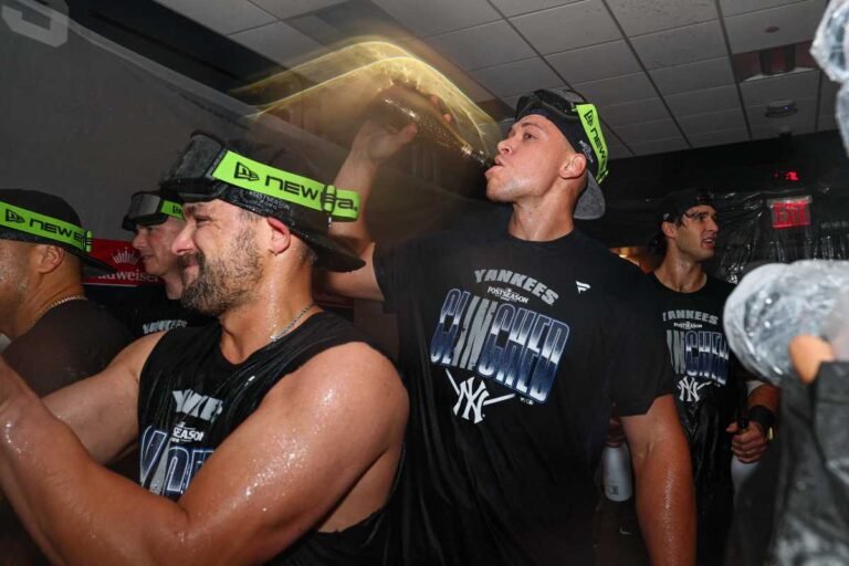 Aaron Judge celebrates with Yankees teammates after their September 30 Wild Card clincher at Yankee Stadium.